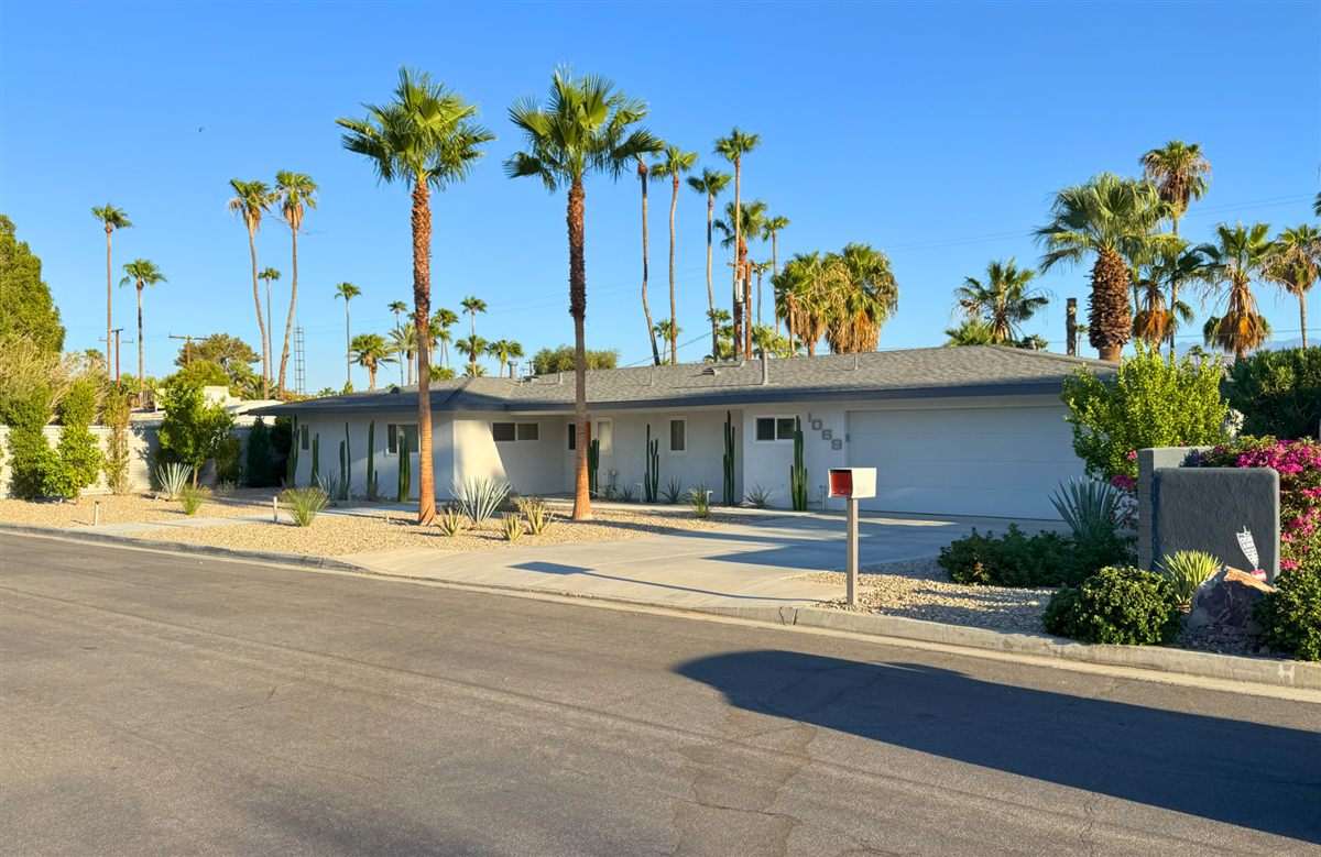 Ranch house at 1069 East Marshall Way lined with palms and cacti