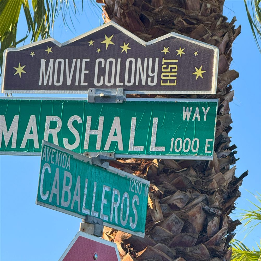 The Movie Colony East blade sign above the Marshall Way and Avenida Caballeros street signs